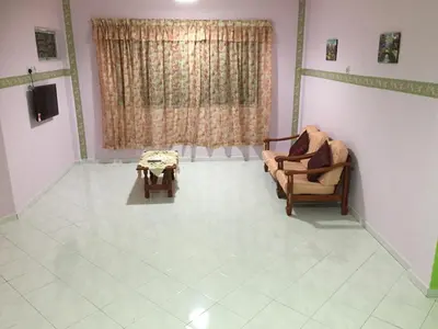 a living room with a couch and a table at Pangkor Damai in Pangkor