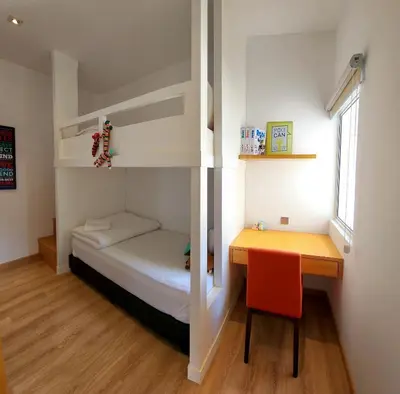 a small room with a bunk bed and a desk at Peony Square Residences in Cameron Highlands