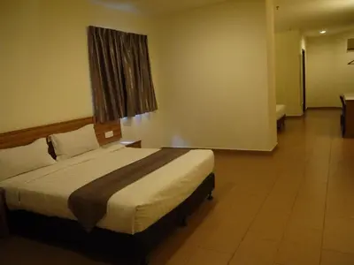 a bedroom with a large bed in a room at Grand Court Hotel in Teluk Intan