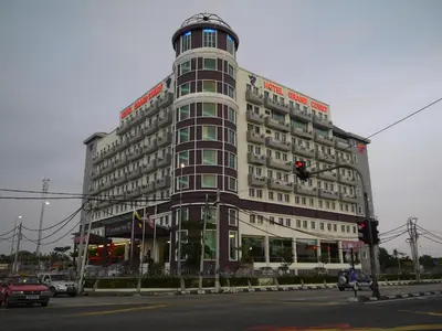 a large building on a city street with a traffic light at Grand Court Hotel in Teluk Intan