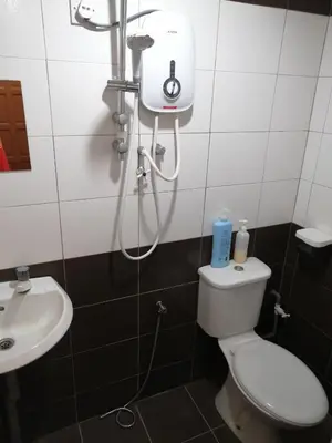 a bathroom with a shower and a toilet and a sink at StarVilla Kinta River Front Medan Istana in Ipoh