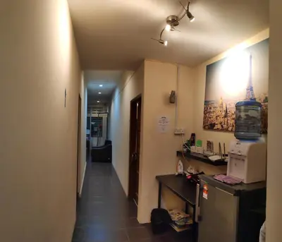 a hallway leading to a room with a kitchen and a microwave at StarVilla Kinta River Front Medan Istana in Ipoh