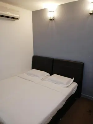 a bed in a room with two white pillows at StarVilla Kinta River Front Medan Istana in Ipoh