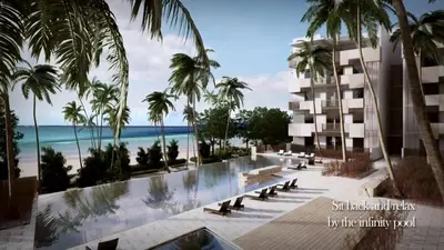 a view of a resort with palm trees and the beach at By The Sea BeachFront Penang in Batu Ferringhi