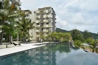 an image of a hotel with a swimming pool at By The Sea BeachFront Penang in Batu Ferringhi