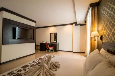 a hotel room with a bed and a tv at De' Garden Hotel, Butterworth in Butterworth