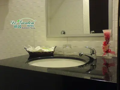 a bathroom counter with a sink and a mirror at De' Garden Hotel, Butterworth in Butterworth