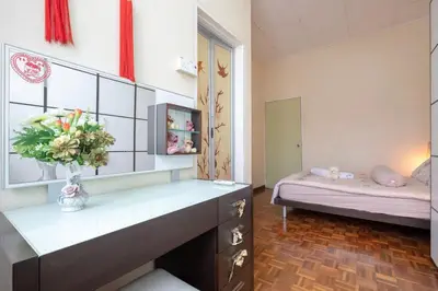 a room with a bed and a vase of flowers at •Lovely Home•11Pax+4Bedrooms+Themed•Bukit Mertajam in Bukit Mertajam