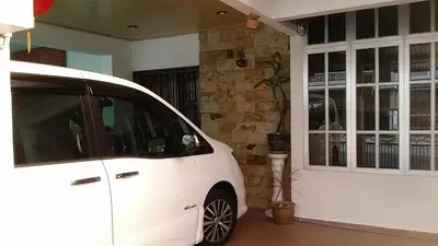 a white car parked in front of a garage at •Lovely Home•11Pax+4Bedrooms+Themed•Bukit Mertajam in Bukit Mertajam