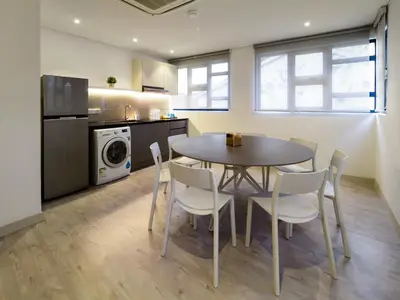 a dining room with a table and chairs in a kitchen at Magazine Vista Hotel Managed by The Ascott Limited in George Town