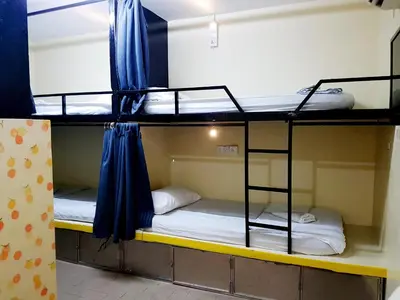 a room with two bunk beds in a dorm room at Abby by the river in Ipoh