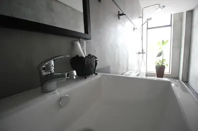 a white bath tub with a faucet in a bathroom at 68 Boutique Hotel in Sitiawan