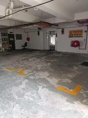 an empty parking garage with yellow markings on the floor at SO Hotel in George Town