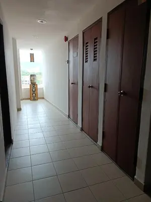 a hallway with doors and a tiled floor at SO Hotel in George Town