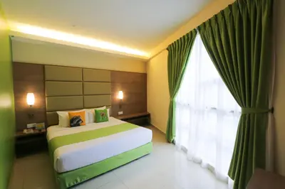 a bedroom with a bed and a large window at Sunway Lost World Hotel in Ipoh