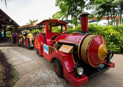 a small red train with people riding on it at Sunway Lost World Hotel in Ipoh
