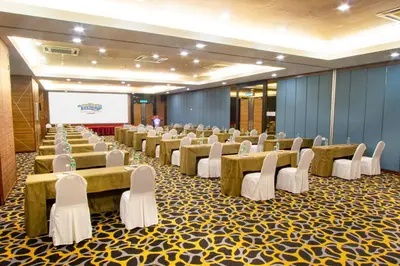 a conference room with tables and chairs and a screen at Sunway Lost World Hotel in Ipoh