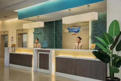 two people standing at a counter in a hospital at Sunway Lost World Hotel in Ipoh