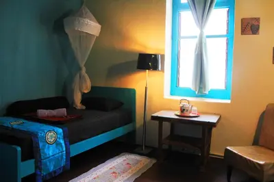 a small bedroom with a bed and a window at MoonTree47 in George Town