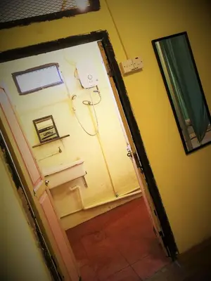 an open door to a bathroom with a sink at MoonTree47 in George Town