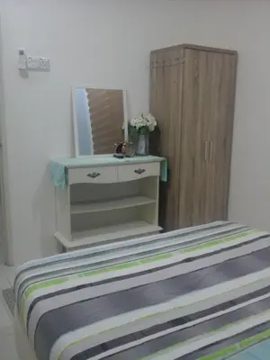 a dressing table with a mirror and a drawer at Miker Homestay in Seri Iskandar