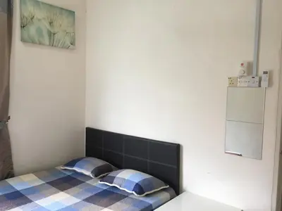 a bed with two pillows on it in a room at Miker Homestay in Seri Iskandar