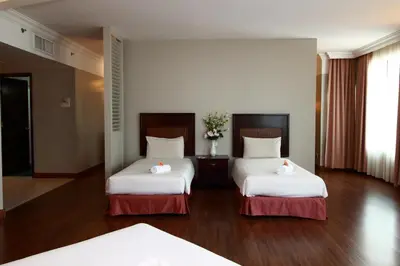a hotel room with two beds with flowers on them at Grand Kampar Hotel in Kampar