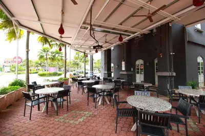 a patio with tables and chairs in a restaurant at Grand Kampar Hotel in Kampar