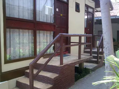 a wooden staircase leading to a house with windows at Pangkor Bay View Beach Resort in Pangkor