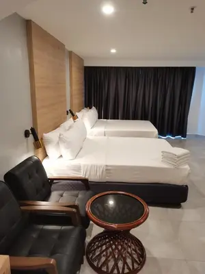 a hotel room with two beds and a couch at Coral Bay Resort in Pangkor