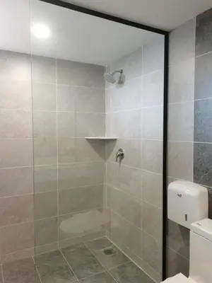 a bathroom with a shower with a glass door at Coral Bay Resort in Pangkor