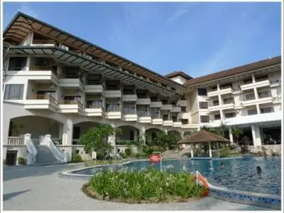 a large building with a swimming pool in front of it at The Orient Star Resort Lumut in Lumut