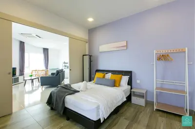 a bedroom with a large bed in a room at JOMSTAY Octagon Ipoh Suites in Ipoh