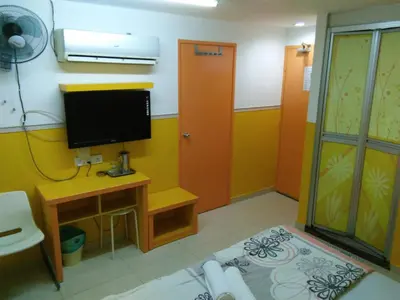 a room with a tv and a desk and a room with a tvictericter at Hotel Abby IGB Tasek in Ipoh