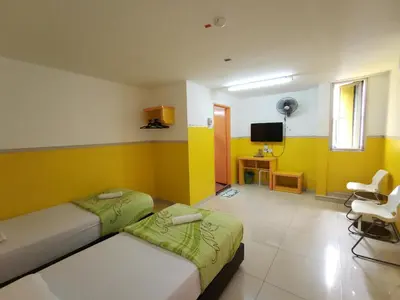 a hotel room with two beds and a tv at Hotel Abby IGB Tasek in Ipoh