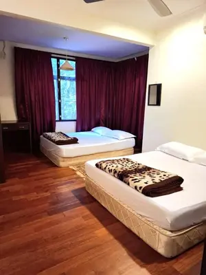 a bedroom with two beds in a room at 5-BEDROOM FERRINGHI HOUSE with WIFI , NETFLIX , BBQ SET , 5 MINUTES WALK to BEACH in Batu Ferringhi