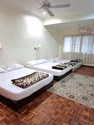 a room with three beds in a room with a ceiling at 5-BEDROOM FERRINGHI HOUSE with WIFI , NETFLIX , BBQ SET , 5 MINUTES WALK to BEACH in Batu Ferringhi