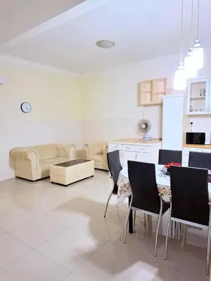 a living room with a couch and a table and chairs at 5-BEDROOM FERRINGHI HOUSE with WIFI , NETFLIX , BBQ SET , 5 MINUTES WALK to BEACH in Batu Ferringhi