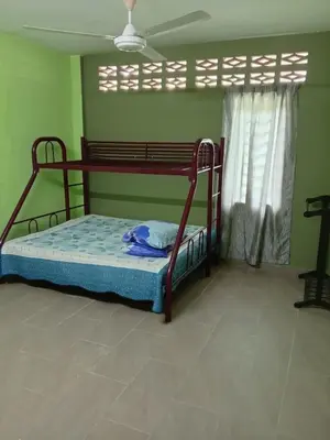 a bedroom with a bunk bed in a room at Panorama Homestay in Jeram