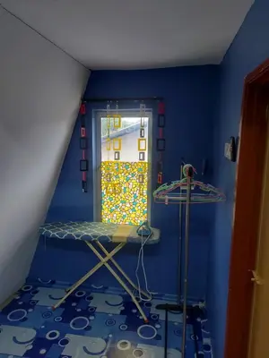 a room with a room with a bed and a window at Panorama Homestay in Jeram