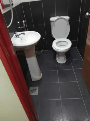 a bathroom with a toilet and a sink at Hotel Sri Malim Sungkai in Sungkai