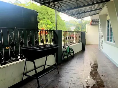 a balcony with a black iron fence and a bike at Sakura Guest House in Cameron Highlands