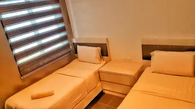 two beds in a small room with a window at Kampar Boutique Hotel (Kampar Sentral) in Kampar