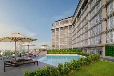 a hotel with a swimming pool and a building at AC Hotel by Marriott Ipoh in Ipoh