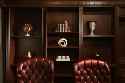 two leather chairs in front of a book shelf at AC Hotel by Marriott Ipoh in Ipoh
