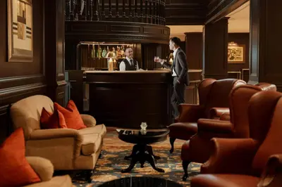 a man standing at a bar in a hotel room at AC Hotel by Marriott Ipoh in Ipoh