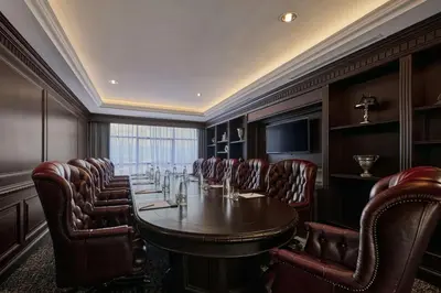 a conference room with a long table and leather chairs at AC Hotel by Marriott Ipoh in Ipoh