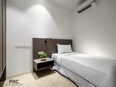 a white bedroom with a bed and a night stand with a plant at Hutton Suite Hotel Managed by The Ascott Limited in George Town