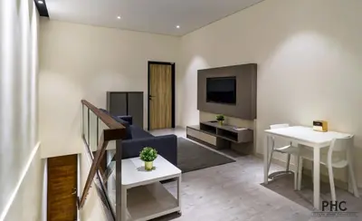 a living room with a couch and a tv at Macallum Central Hotel Managed by The Ascott Limited in George Town