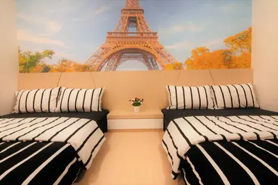 two beds in a room with the eiffel tower at H2H - Nichole Maison - Majestic Ipoh in Ipoh